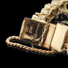 Load image into Gallery viewer, A close-up of a yellow gold bracelet clasp stamped PAT PEND and safety chain, on a black background