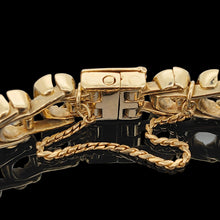 Load image into Gallery viewer, A close-up of a yellow gold bracelet clasp and safety chain, on a black background