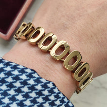 Load image into Gallery viewer, An oval link bracelet in yellow gold modelled on a wrist