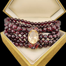 Load image into Gallery viewer, A five row round garnet bead bracelet with a citrine and garnet clasp in yellow gold, in a vintage box