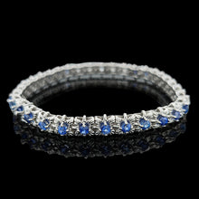 Load image into Gallery viewer, A sapphire and diamond white gold line bracelet, on a black background