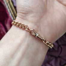 Load image into Gallery viewer, A rose gold curb link bracelet, modelled on a wrist