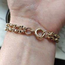 Load image into Gallery viewer, A double row oval and bead link bracelet in yellow gold, modelled on a wrist