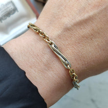 Load image into Gallery viewer, A yellow and white gold link bracelet, modelled on a wrist