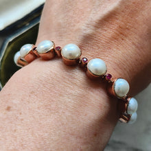 Load image into Gallery viewer, A pearl and ruby bracelet in rose gold, modelled on a wrist