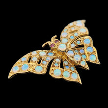 Load image into Gallery viewer, A yellow gold butterfly brooch with opals and ruby eyes, on a black background