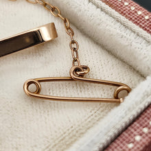 Load image into Gallery viewer, Close-up of a safety pin attachment on a gold brooch