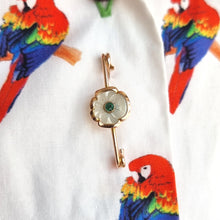 Load image into Gallery viewer, Antique 9ct Gold Mother of Pearl and Emerald Flower Bar Brooch modelled on the front of a shirt with parrots on
