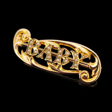Load image into Gallery viewer, A yellow gold brooch with the word BABY written in pearls, on a black background