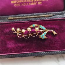 Load image into Gallery viewer, Gold brooch with pearls and turquoise stones on a purple velvet background