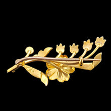 Load image into Gallery viewer, A yellow gold floral brooch, against a black background
