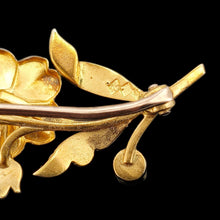 Load image into Gallery viewer, A yellow gold floral brooch, against a black background