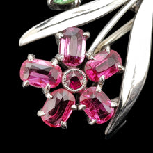 Load image into Gallery viewer, Close-up of a ruby and green zircon flower bouquet brooch in white and rose gold, on a black background