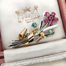 Load image into Gallery viewer, A ruby and green zircon flower bouquet brooch in white and rose gold, sitting in an antique box
