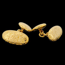 Load image into Gallery viewer, A pair of yellow gold engraved oval and round cufflinks, on a black background