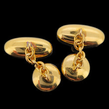Load image into Gallery viewer, A pair of yellow gold engraved oval and round cufflinks, on a black background