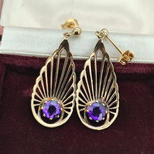 Load image into Gallery viewer, A pair of pear shaped fan design drop earrings with amethysts in yellow gold, in an antique jewellery box