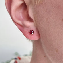 Load image into Gallery viewer, 18ct Yellow Gold Ruby Solitaire Stud Earrings modelled in the ear, a close-up view
