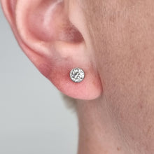 Load image into Gallery viewer, Close-up of an ear wearing a diamond stud earring against a neutral background