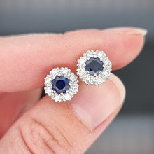 Load image into Gallery viewer, 18ct White Gold Sapphire and Diamond Cluster Stud Earrings held in the hand