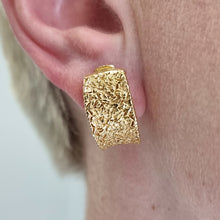 Load image into Gallery viewer, Nicolis Cola 18ct Yellow Gold Textured Half Hoop Earrings modelled in the ear