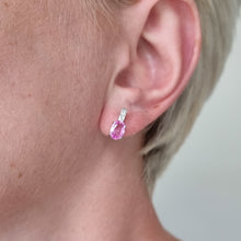Load image into Gallery viewer, Close-up of an ear wearing a pink sapphire and diamond earring with a blurred background