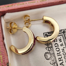 Load image into Gallery viewer, A pair of yellow gold hoop earrings channel set with square cut rubies