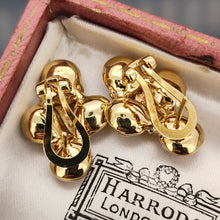 Load image into Gallery viewer, A pair of cluster earrings in yellow gold, with hinged clips and post fittings, in an antique box