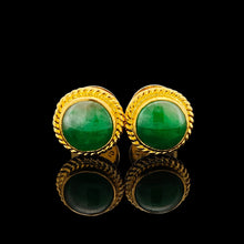 Load image into Gallery viewer, A pair of round jade stud earrings in yellow gold, on a black background