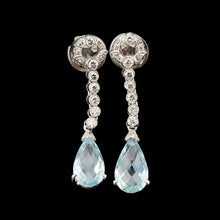 Load image into Gallery viewer, A pair of aquamarine and diamond drop earrings in white gold, on a black background