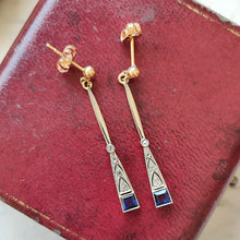 Load image into Gallery viewer, A pair of sapphire and diamond long drop earrings in white and yellow gold, on a red box