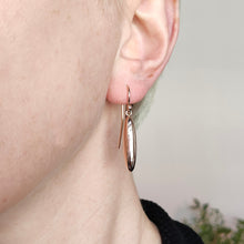 Load image into Gallery viewer, A rose gold elongated drop earring with a hook fitting, modelled in an ear