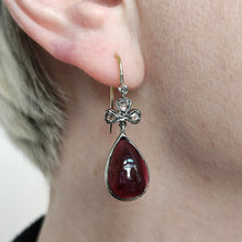 Load image into Gallery viewer, A pear shaped garnet and rose cut diamond earring in gold and silver, modelled in an ear