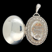 Load image into Gallery viewer, Silver locket with intricate designs on a black background