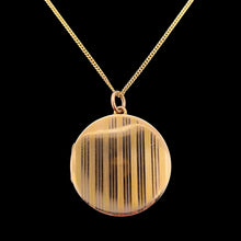Load image into Gallery viewer, A circular yellow gold locket with pinstripe engraving, with a gold chain