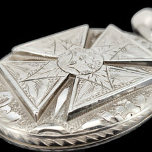 Load image into Gallery viewer, An intricate engraved oval locket pendant in silver, on a black background