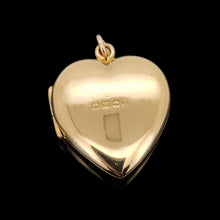 Load image into Gallery viewer, A yellow gold heart shaped locket, on a black background