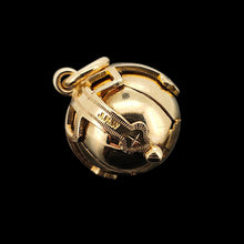 Load image into Gallery viewer, A folding masonic ball fob pendant in gold and silver, on a black background