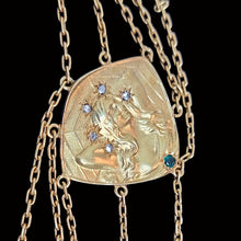 Load image into Gallery viewer, Gold necklace with a detailed pendant featuring a woman and gemstones on a black background