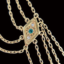 Load image into Gallery viewer, Gold necklace with a diamond and emerald pendant on a black background