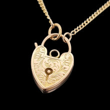 Load image into Gallery viewer, Gold heart-shaped lock pendant on a chain against a black background