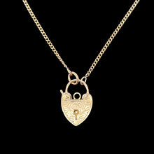 Load image into Gallery viewer, Gold heart-shaped padlock necklace on a black background