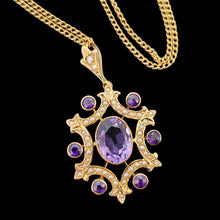 Load image into Gallery viewer, An amethyst and seed pearl fancy pendant in yellow gold with a curb link chain, on a black background