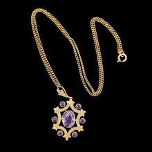 Load image into Gallery viewer, An amethyst and seed pearl fancy pendant in yellow gold with a curb link chain, on a black background