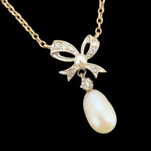 Load image into Gallery viewer, A yellow and white gold pearl and diamond bow pendant necklace