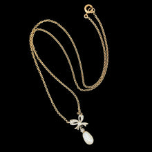 Load image into Gallery viewer, A yellow and white gold pearl and diamond bow pendant necklace