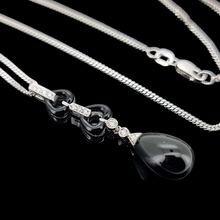 Load image into Gallery viewer, 18ct & 9ct White Gold Onyx and Diamond Drop Necklace laying down