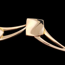 Load image into Gallery viewer, Close-up of a rose gold link from a necklace, against a black background