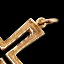 Load image into Gallery viewer, A close-up of a 9ct hallmark on a yellow gold cross pendant, on a black background