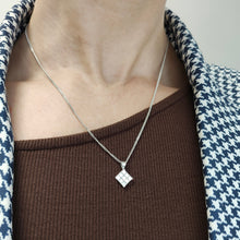Load image into Gallery viewer, A square shaped diamond cluster pendant in white gold with a curb link chain, modelled on a woman